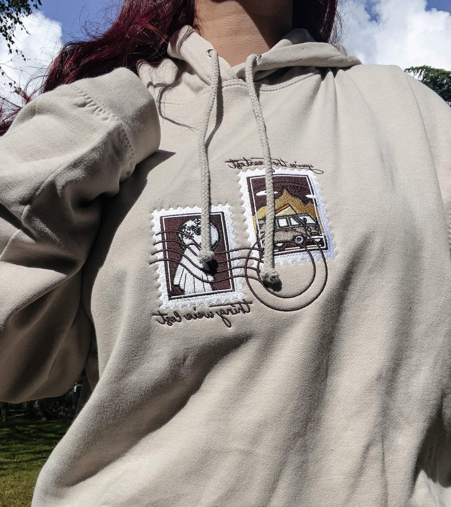 Model wearing natural stone embroidered sweatshirt with Noah Kahan You're Gonna Go Far lyrics - what to wear to a noah kahan show