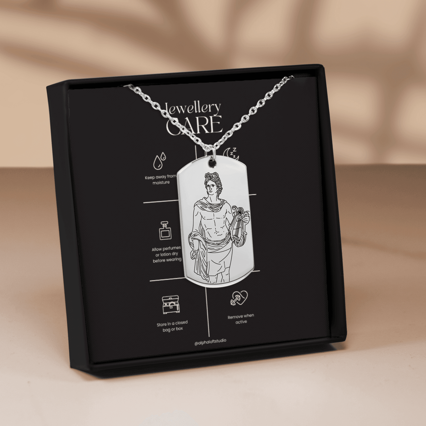Apollo mythology necklace in packaging showing front and back engraved designs