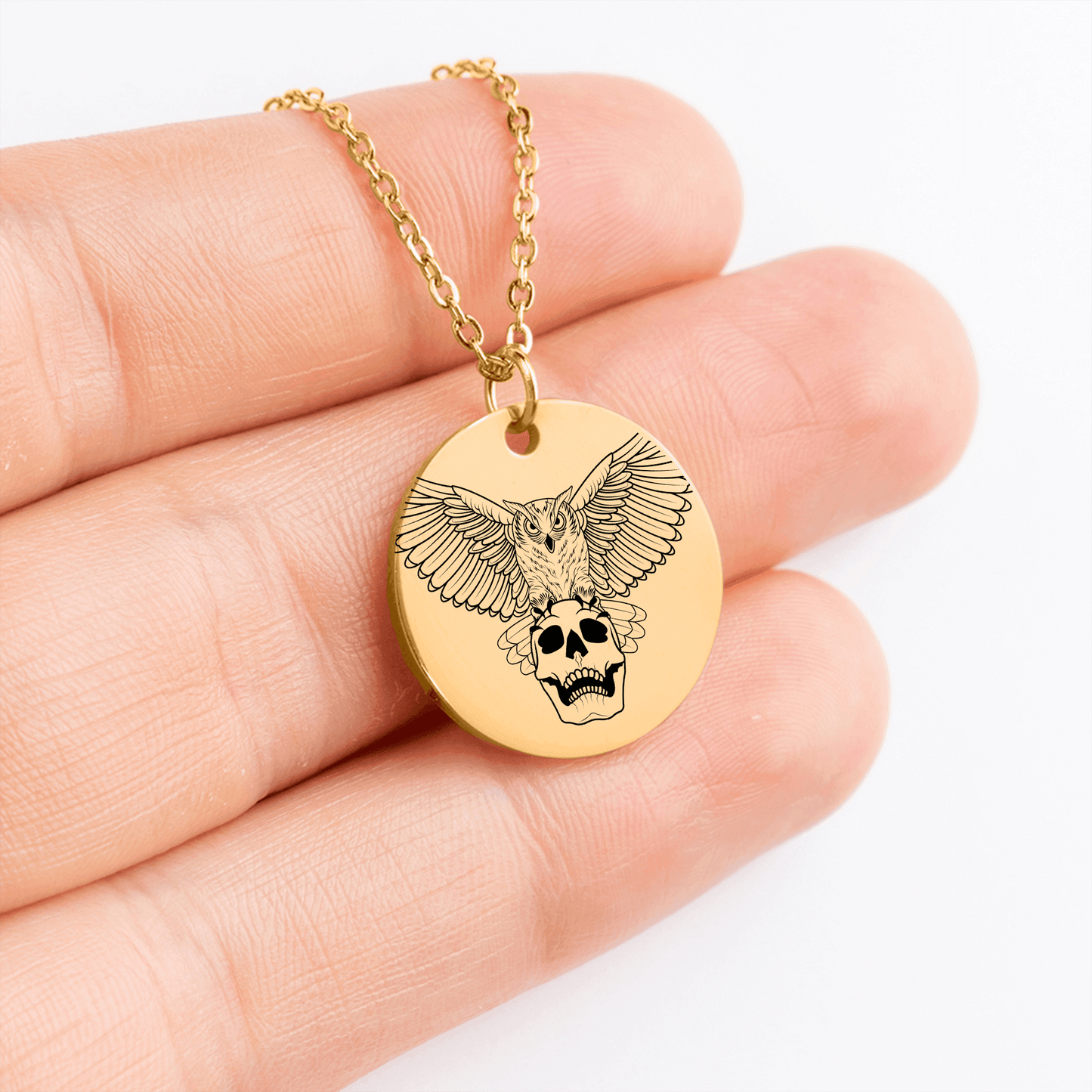 Model holding Hades hand-drawn mythology necklace - styled for everyday wear