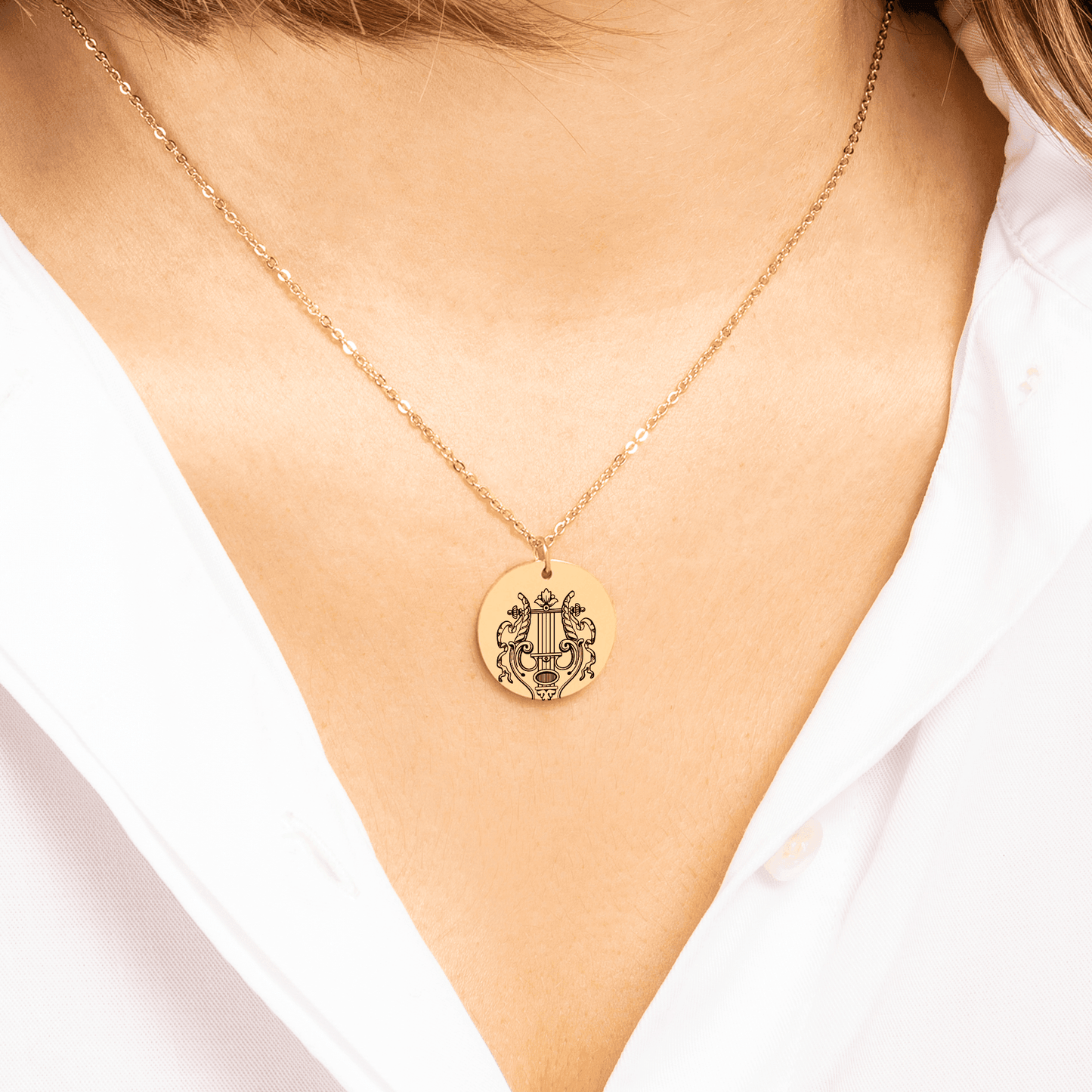 Model wearing ancient greek jewellery Orpheus and Eurydice necklace in gold.