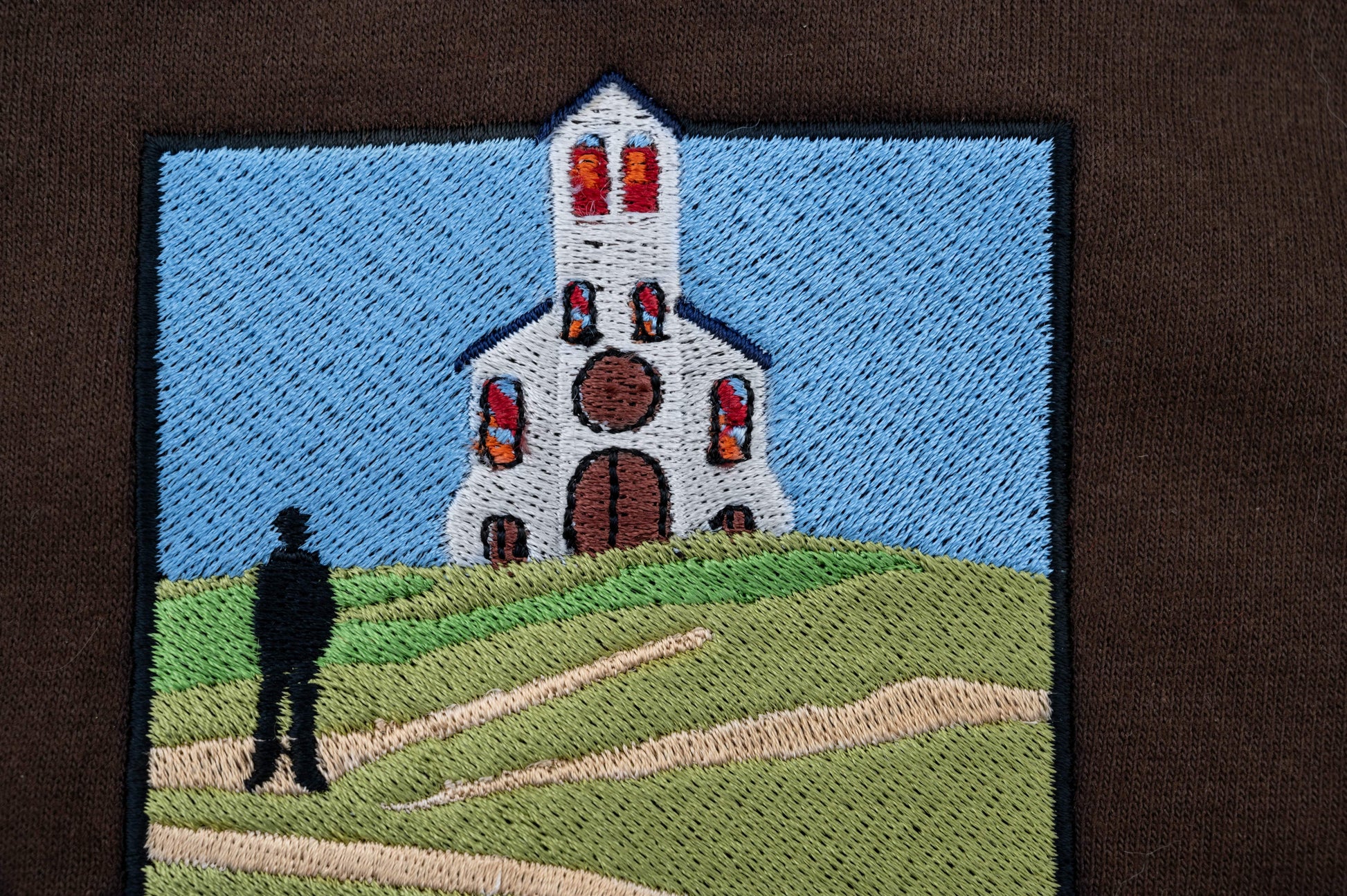 Embroidery closeup of The Great Divide stained glass design zip up hoodie in brown - noah kahan concert outfit 