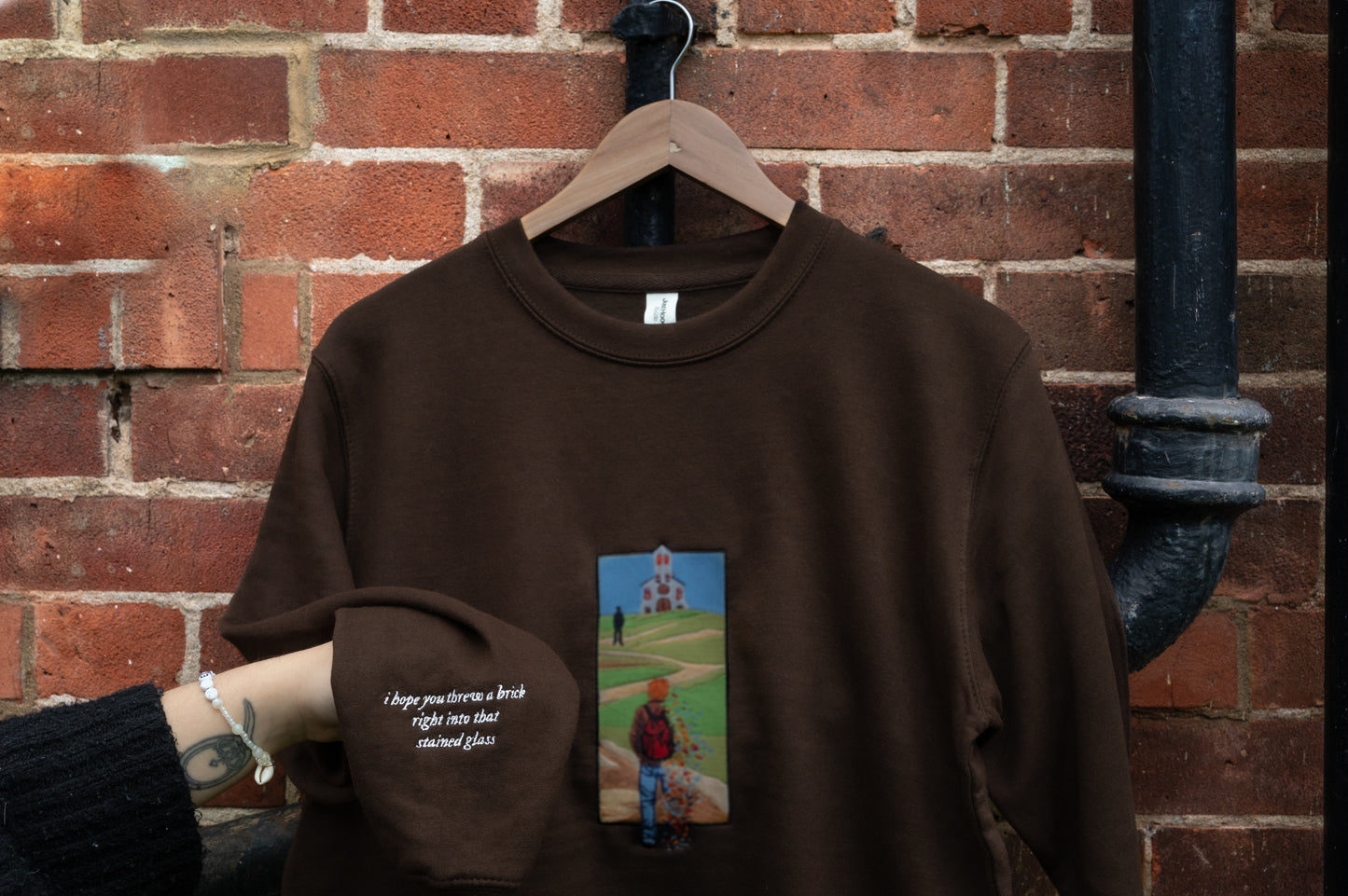 Sleeve detail closeup of The Great Divide stained glass design t-shirt in brown - noah kahan concert outfit 