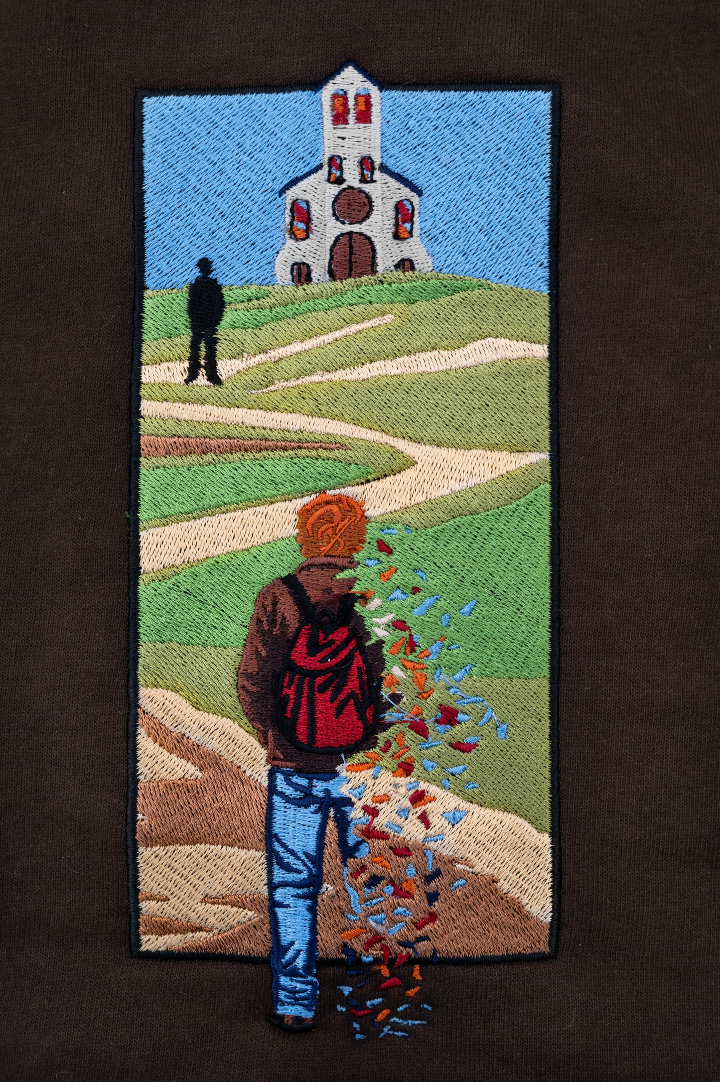 Embroidery closeup of The Great Divide stained glass design t-shirt in brown - noah kahan concert outfit 